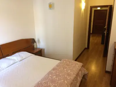 a bedroom with a bed and a hallway at Downtown PORTO SE in Porto