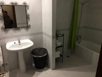 a bathroom with a sink and a mirror and a shower at Downtown PORTO SE in Porto