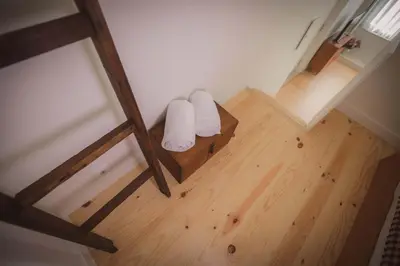 a room with two white towels on a wooden floor at Bonfim 234 Townhouse in Porto