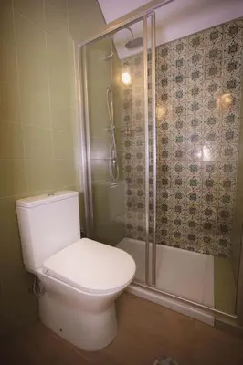 a bathroom with a toilet and a shower at Bonfim 234 Townhouse in Porto