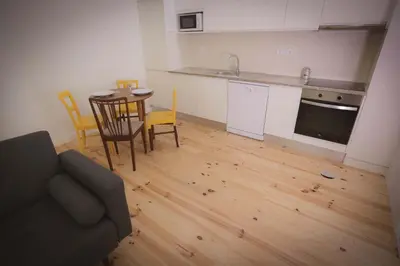 a kitchen and dining room with a table and chairs at Bonfim 234 Townhouse in Porto