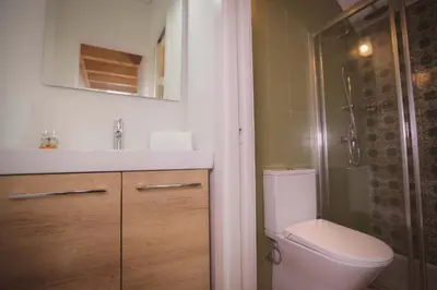 a bathroom with a toilet and a sink and a shower at Bonfim 234 Townhouse in Porto