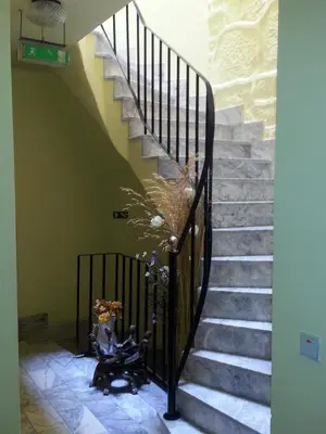 a set of stairs with people sitting on them at Caldeira Guest House in Porto