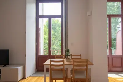 a dining room with a table and chairs at CL Fernandes Tomás I in Porto