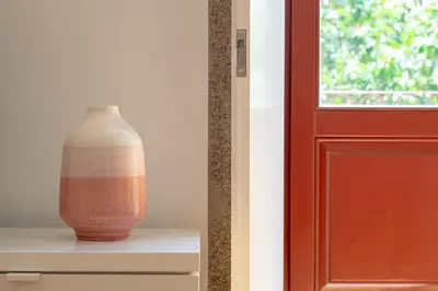 a vase sitting on a shelf next to a door at CL Fernandes Tomás I in Porto