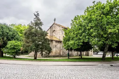 an old church with trees in front of it at Alberti's House Oporto Central Apartment in Porto