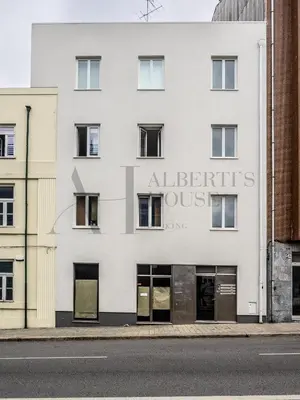a white building with a sign that reads at Alberti's House Oporto Central Apartment in Porto