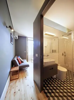a bathroom with a sink and a toilet and a tub at Oporto Maison Batalha in Porto