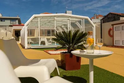 a table with a plate of fruit and a bottle of juice at 731 Costa Cabral Metro Residence in Porto