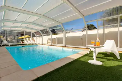 an indoor swimming pool with a large ceiling and windows at 731 Costa Cabral Metro Residence in Porto