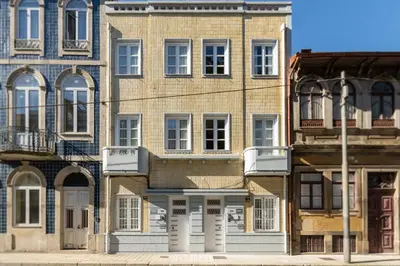 an old brick building with white doors and windows at 731 Costa Cabral Metro Residence in Porto