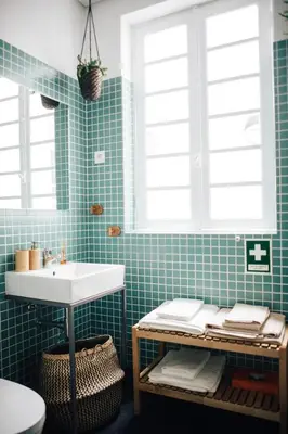 a bathroom with a sink and green tiles at Wood Loft by RDC in Porto