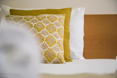 a pillow sitting on top of a bed at Spot Apartments Trindade in Porto