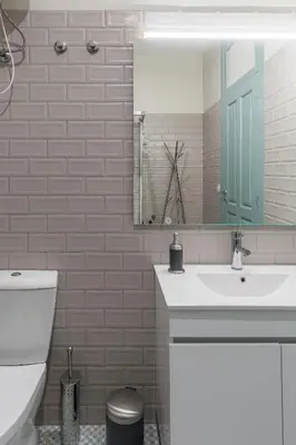 a bathroom with a toilet and a sink and a mirror at Santa Catarina 652 in Porto