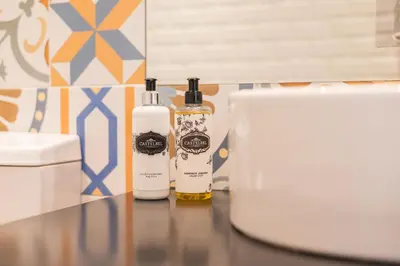 two bottles of essential oils sitting on a table at Panoramic luxury apartment w AC Downtown and Metro in Porto