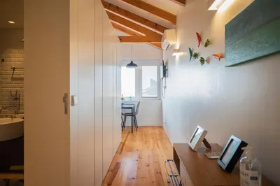 a room with a hallway with a table and a window at Panoramic luxury apartment w AC Downtown and Metro in Porto