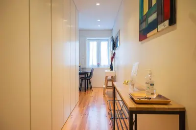 a hallway with a table and a dining room at Modern loft w AC Downtown and Metro in Porto