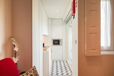 a small apartment with a black and white floor at Modern loft w AC Downtown and Metro in Porto