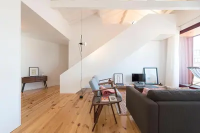 a living room with a couch and a table at LovelyStay - Top Floor Balcony Apartment in Porto