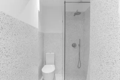 a bathroom with a shower with a toilet and a shower at Goabio apartments 2 river view in Porto