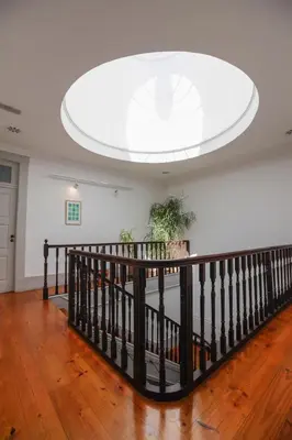 a room with a staircase with a large ceiling at Pensao Favorita in Porto