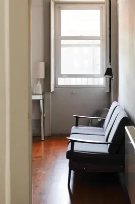 a living room with a couch and a window at Pensao Favorita in Porto