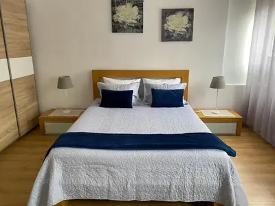 a bedroom with a large bed with blue pillows at Guest house D. Filipe I in Porto