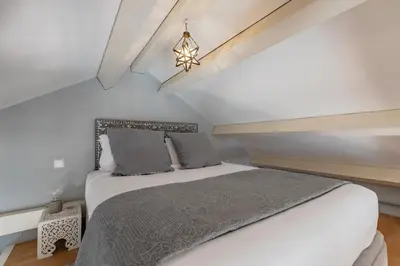 a bedroom with a large bed in a attic at Oporto LightHouse Apartment by DA'HOME in Porto