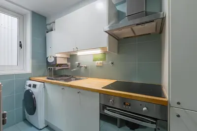 a kitchen with a sink and a washing machine at Oporto LightHouse Apartment by DA'HOME in Porto
