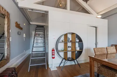 a room with a ladder and a mirror at Oporto LightHouse Apartment by DA'HOME in Porto
