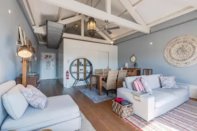 a living room with a white couch and a table at Oporto LightHouse Apartment by DA'HOME in Porto