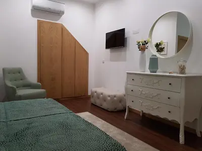 a bedroom with a bed and a mirror and a dresser at 22 Oporto Guesthouse in Porto