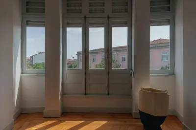an empty room with a door and windows at Baixa24 - Downtown Bliss w/ Amazing Natural Light in Porto