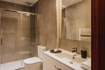 a bathroom with a toilet and a sink and a shower at Premium Apartment with Private Terrace & Garage in Porto