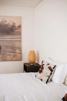 a bedroom with a white bed with a picture on the wall at Premium Apartment with Private Terrace & Garage in Porto