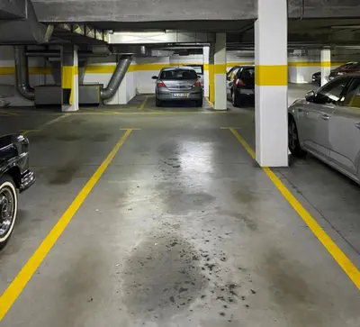 a parking garage with two cars parked in it at Premium Apartment with Private Terrace & Garage in Porto