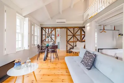 a living room with a couch and a table at YOUROPO - City Center Ribeira Porto in Porto