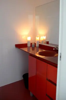 a bathroom with a sink and two candles on a counter at Porto Smart Apartments - Downtown in Porto