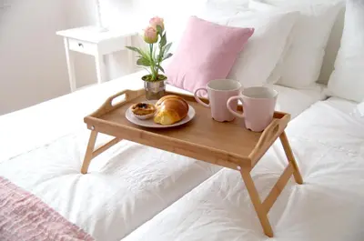 a tray with a plate of pastries and two cups on a bed at Porto Smart Apartments - Downtown in Porto