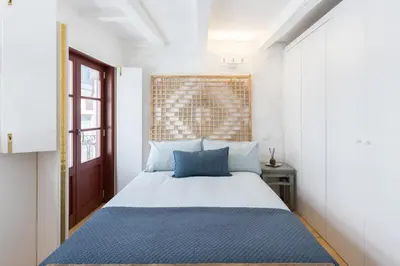 a bedroom with a large bed with blue pillows at VIVA Caldeireiros Porto Old Town in Porto