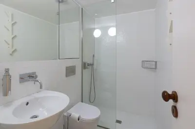 a bathroom with a shower and a toilet and a sink at VIVA Caldeireiros Porto Old Town in Porto