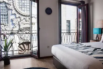a bedroom with a bed and a balcony at Nations Porto - Studios & Suites in Porto