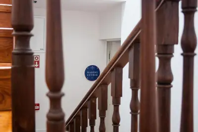 a stairway with a blue sign on a wall at Nations Porto - Studios & Suites in Porto