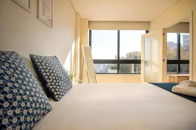 a bedroom with a large bed with two pillows on it at Green Suite in Porto
