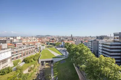 an aerial view of a city with buildings and trees at Green Suite in Porto