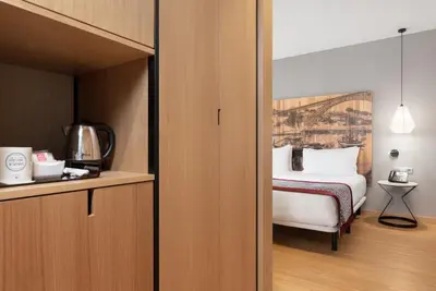 a bedroom with a bed and a cupboard at Eurostars Porto Centro in Porto