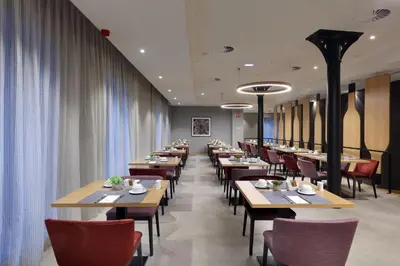 a row of tables and chairs in a restaurant at Eurostars Porto Centro in Porto