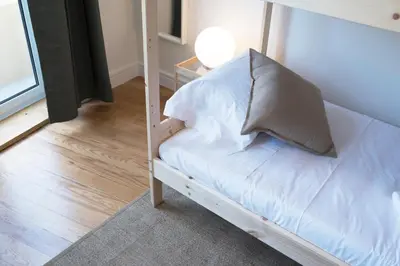 a white couch with a pillow on it in a room at Sleep in Centre Downtown in Porto