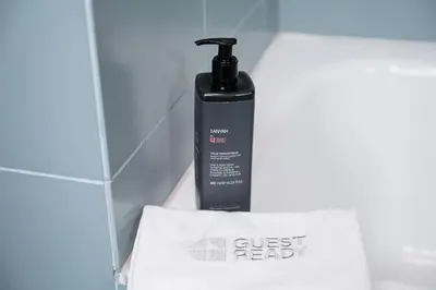 a black bottle of guest ready on a white towel at GuestReady - Cosy studio in the heart of Porto in Porto