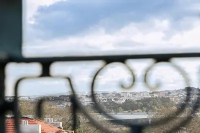 a view of a city from a wire fence at GuestReady - Cosy studio in the heart of Porto in Porto